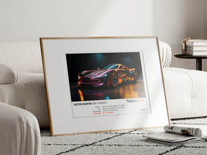 Framed print of an Aston Martin concept car on a coffee table in a living room.